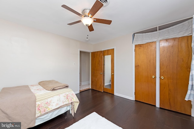 bedroom with dark hardwood / wood-style floors and ceiling fan