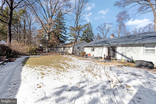 snow covered house featuring a patio area