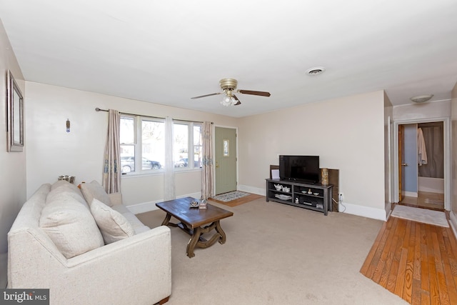 carpeted living room featuring ceiling fan