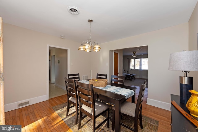 dining space with an inviting chandelier and hardwood / wood-style floors