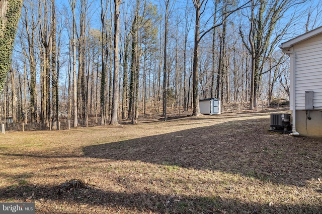 view of yard with a storage shed and central AC unit