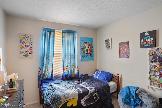 carpeted bedroom with multiple windows and a textured ceiling