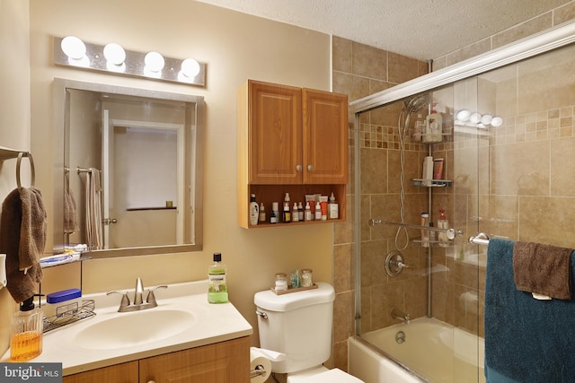 full bathroom featuring vanity, combined bath / shower with glass door, a textured ceiling, and toilet