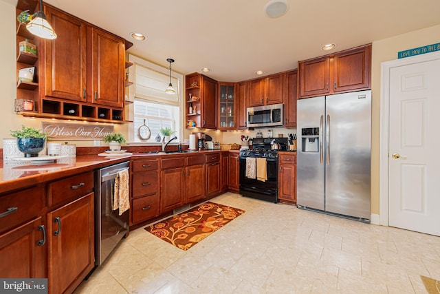 kitchen with appliances with stainless steel finishes, decorative light fixtures, and sink