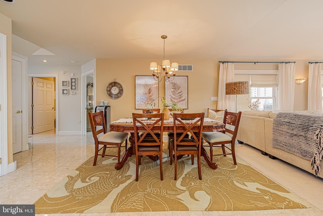 dining space with a chandelier