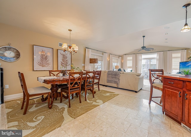 dining space featuring lofted ceiling and ceiling fan with notable chandelier