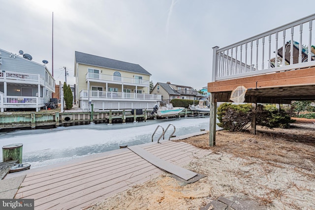 view of dock featuring a water view and a balcony