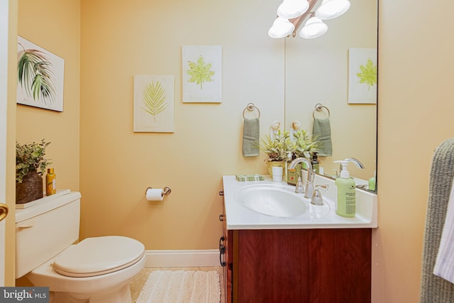 bathroom featuring vanity, tile patterned floors, a chandelier, and toilet