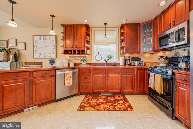 kitchen featuring hanging light fixtures, sink, and appliances with stainless steel finishes