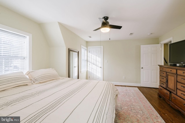 bedroom with dark hardwood / wood-style flooring and ceiling fan