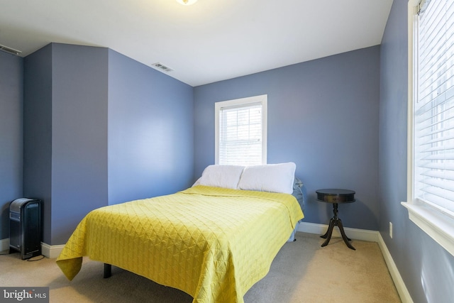 bedroom featuring light carpet