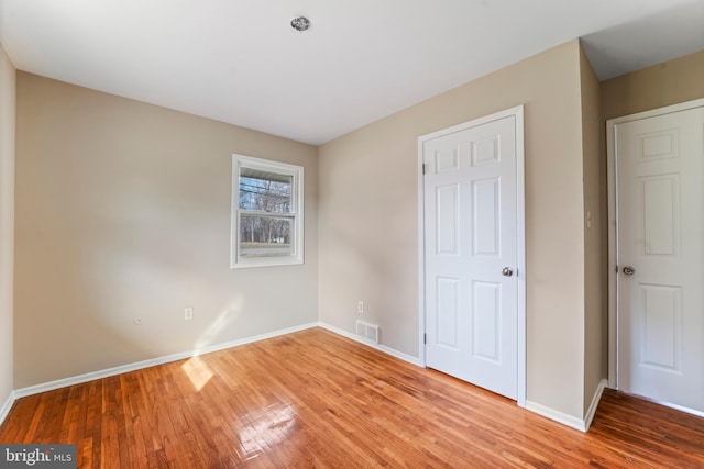 unfurnished bedroom featuring light wood-type flooring