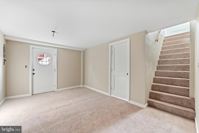 view of carpeted foyer entrance