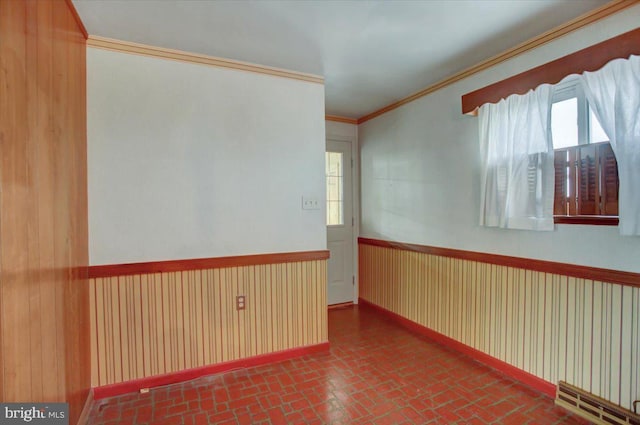 unfurnished room with crown molding