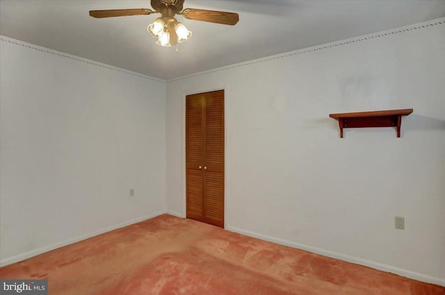 carpeted empty room featuring ceiling fan