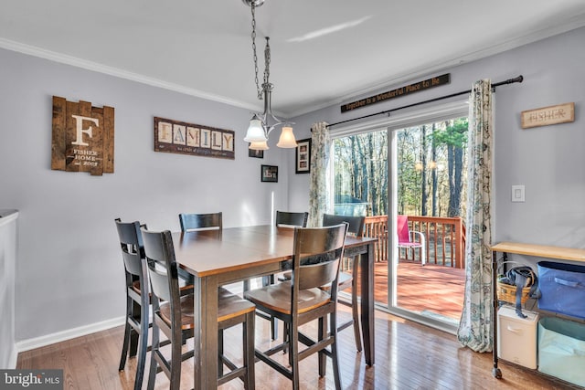 dining area featuring crown molding and wood-type flooring