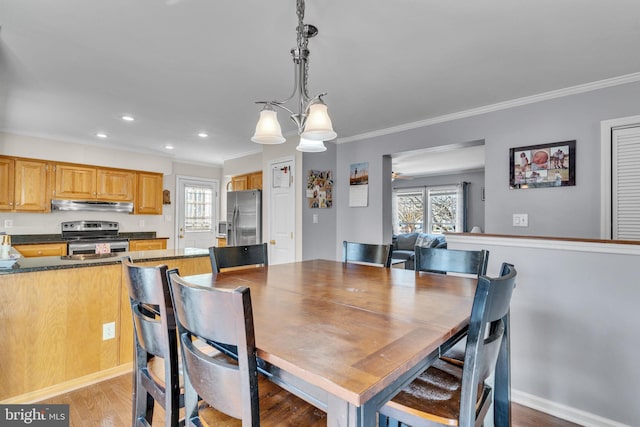 dining space with crown molding, a healthy amount of sunlight, and light hardwood / wood-style flooring