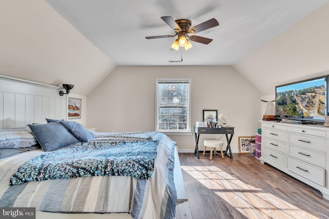 bedroom featuring hardwood / wood-style flooring, vaulted ceiling, and ceiling fan