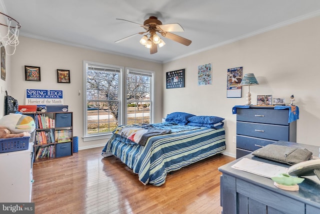 bedroom featuring hardwood / wood-style flooring, crown molding, and ceiling fan