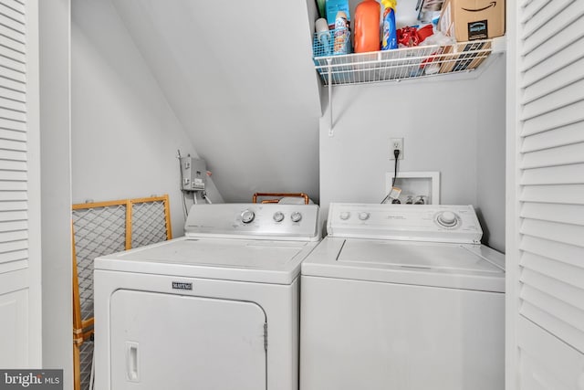 clothes washing area featuring separate washer and dryer