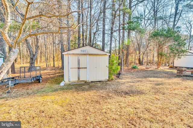 view of outbuilding featuring a yard