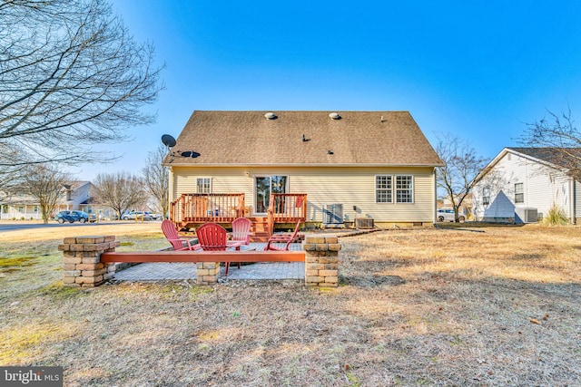 rear view of property with central AC and a deck