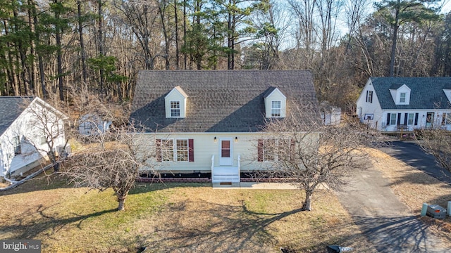 cape cod home with a front yard