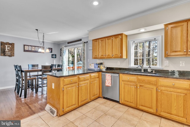 kitchen featuring sink, hanging light fixtures, ornamental molding, stainless steel dishwasher, and kitchen peninsula