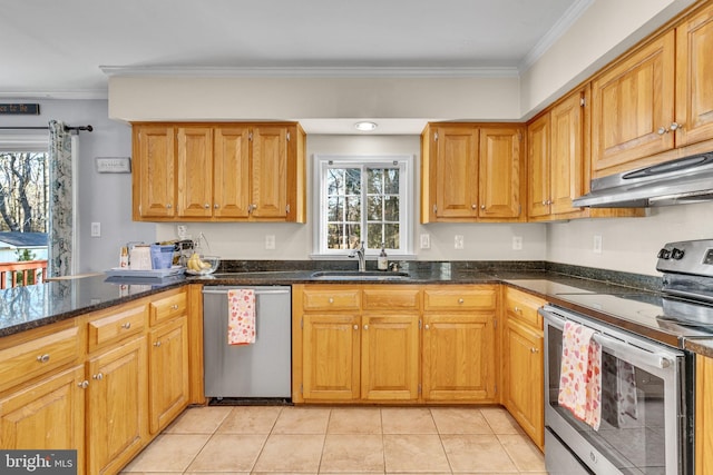 kitchen with sink, appliances with stainless steel finishes, ornamental molding, light tile patterned flooring, and dark stone counters