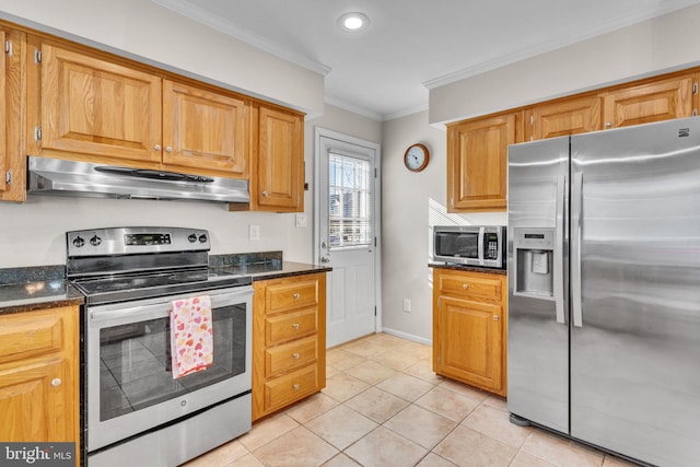 kitchen with ornamental molding, light tile patterned floors, stainless steel appliances, and dark stone counters