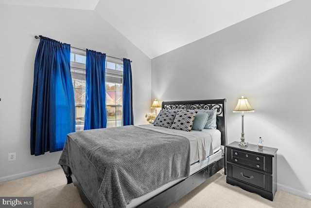 carpeted bedroom with vaulted ceiling