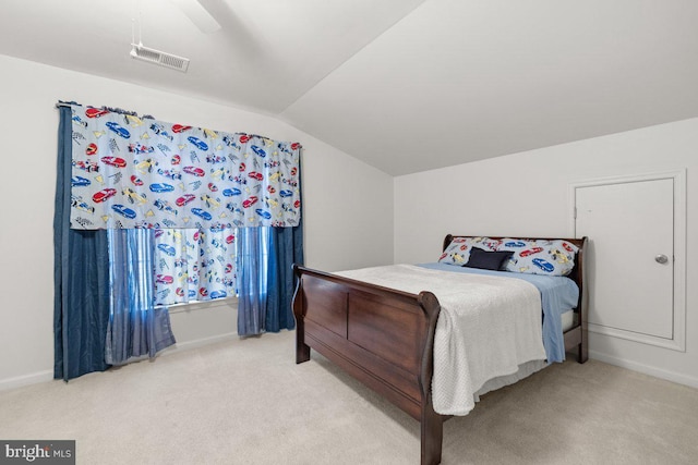 bedroom with ceiling fan, lofted ceiling, and carpet flooring