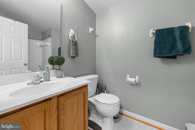 bathroom with vanity, tile patterned floors, toilet, and a tile shower