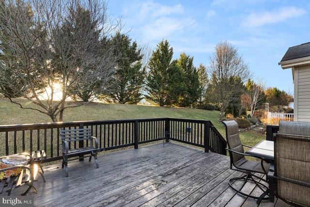 wooden deck featuring a lawn