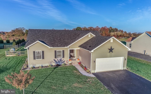 ranch-style home featuring a garage and a front lawn