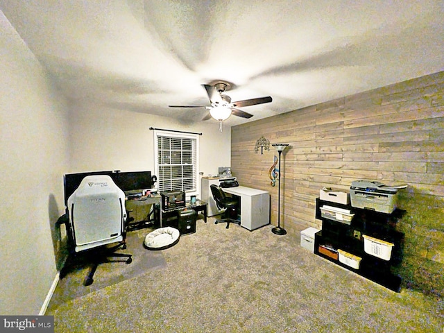 office space with ceiling fan, carpet flooring, a textured ceiling, and wood walls