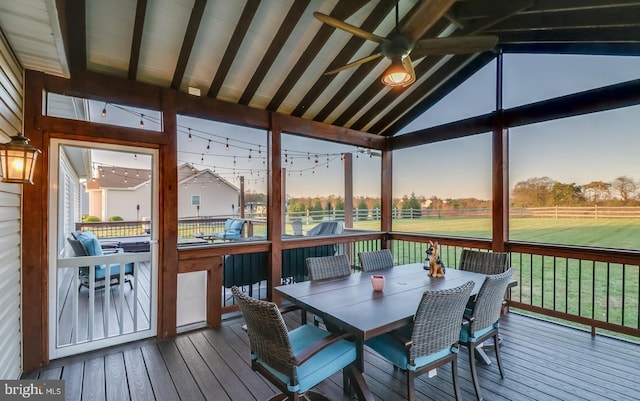 sunroom / solarium with lofted ceiling with beams and ceiling fan