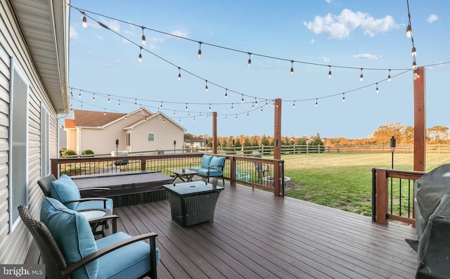 wooden terrace with a lawn, a rural view, outdoor lounge area, a grill, and a covered hot tub