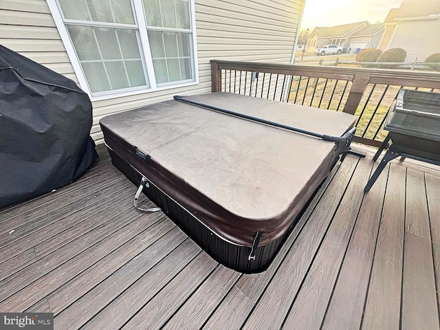 wooden deck featuring grilling area and a covered hot tub