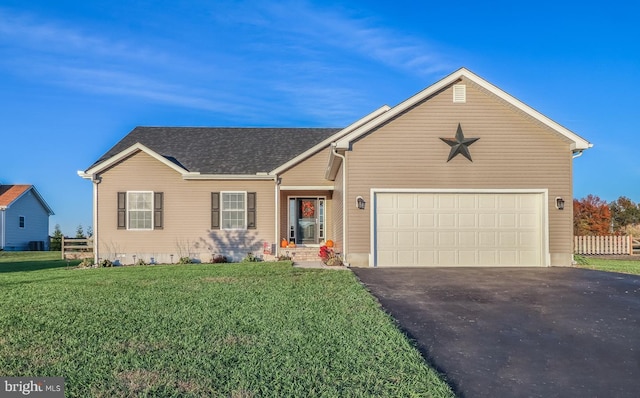 ranch-style house featuring a garage and a front lawn