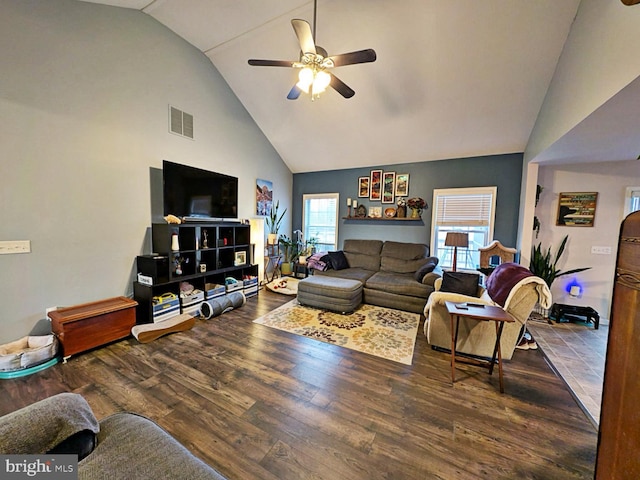 living room featuring dark hardwood / wood-style flooring, high vaulted ceiling, and ceiling fan