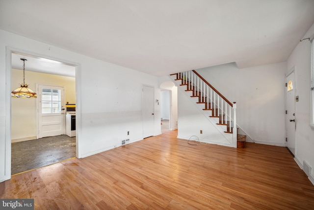 unfurnished living room featuring hardwood / wood-style flooring