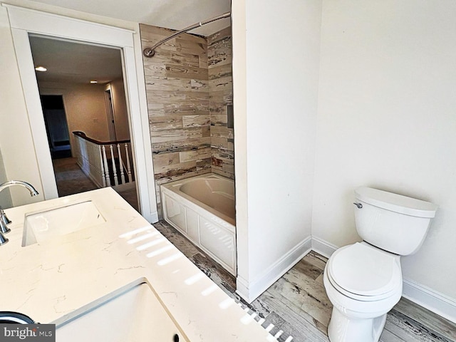 bathroom with toilet, shower / bath combination, a sink, and wood finished floors