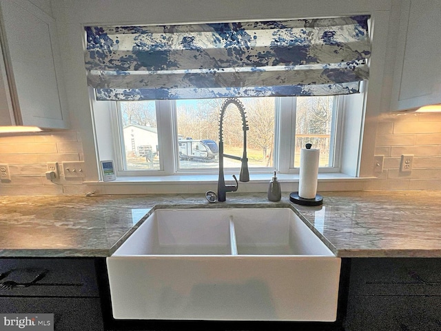 interior details with backsplash and a sink