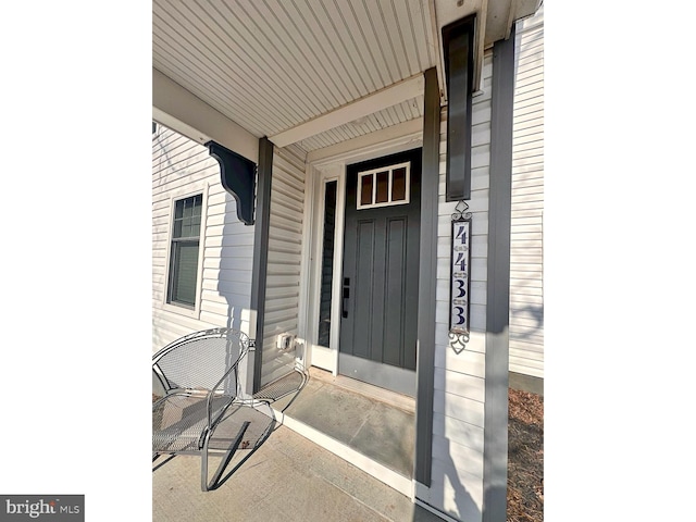 entrance to property featuring covered porch