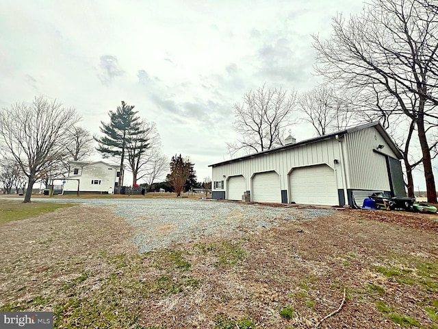 view of property exterior featuring an outbuilding and a detached garage