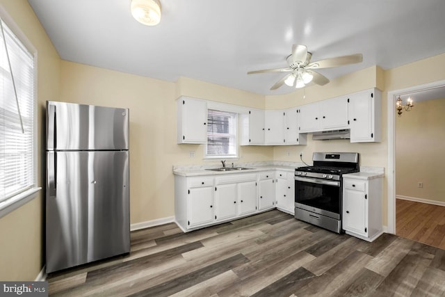 kitchen with white cabinetry, sink, dark hardwood / wood-style flooring, ceiling fan, and stainless steel appliances