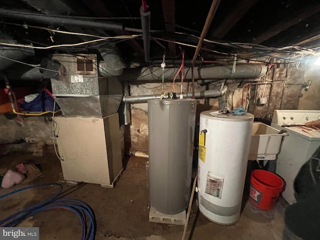 utility room with washer / clothes dryer, gas water heater, and sink