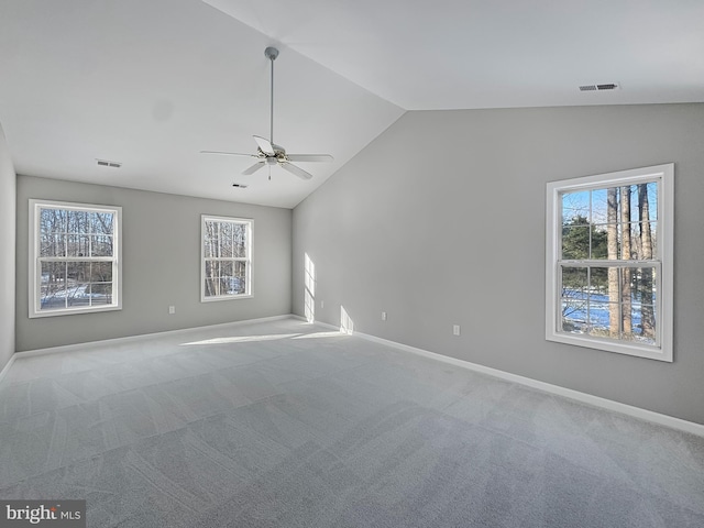 carpeted spare room with vaulted ceiling and ceiling fan