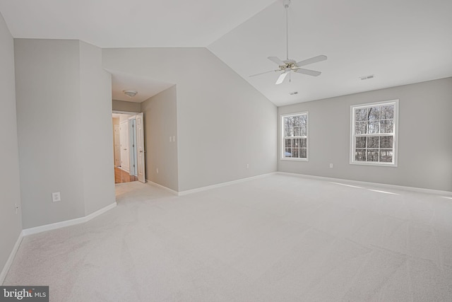 carpeted spare room with vaulted ceiling and ceiling fan